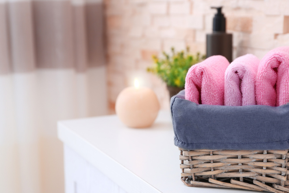 Towels in wicker basket in bathroom