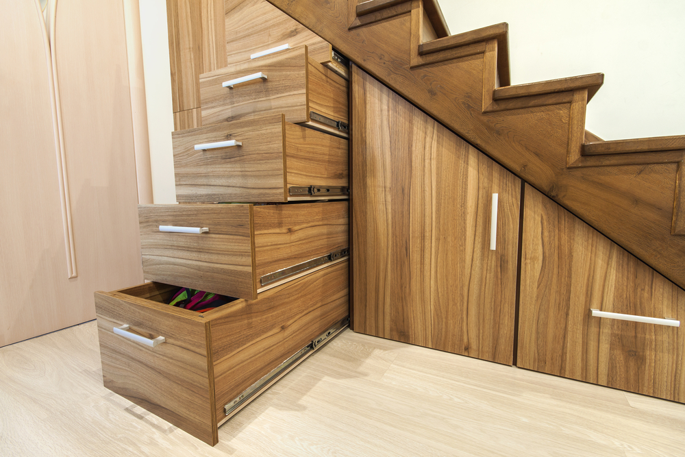 Sliding drawers and pullout storage under stair space.