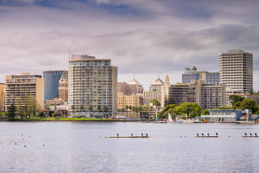 downtown oakland skyline from the bay with clouds in sky