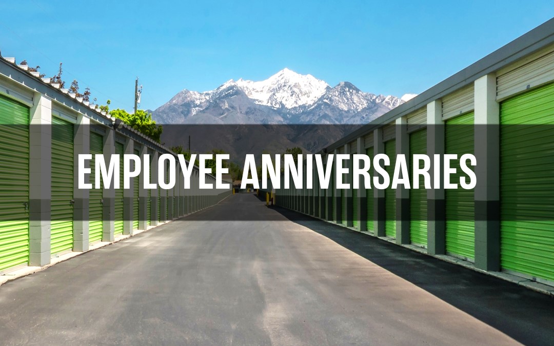 "Employee Anniversaries" text overlay on Extra Space Storage units with mountains in the background